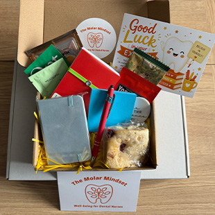 gift box with dental care items including snacks and wellness products for two dental professionals